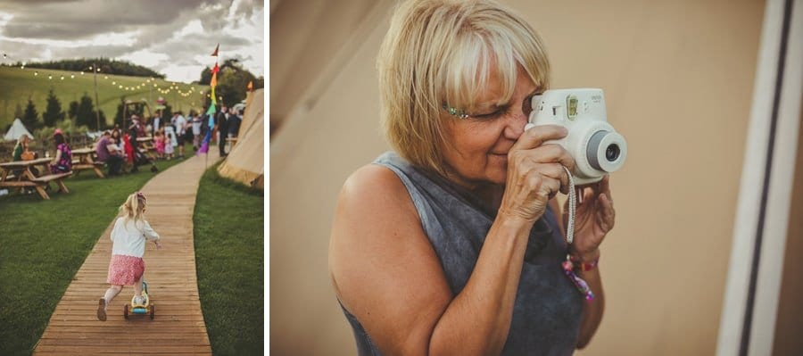 A wedding guest takes a photograph with a polaroid camera
