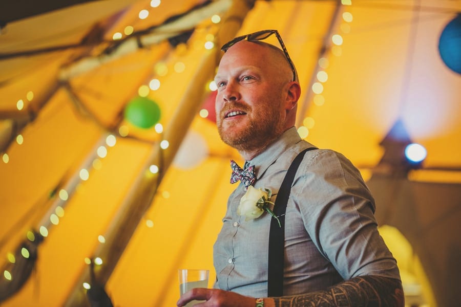 The best man smiles at the wedding party