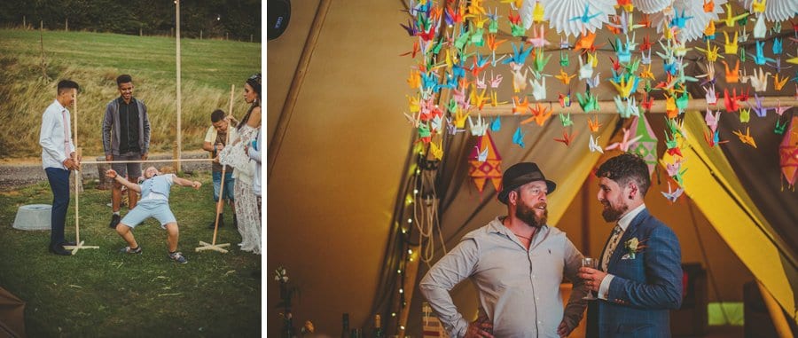 A little boy tries to go under a wooden cane in the gardens