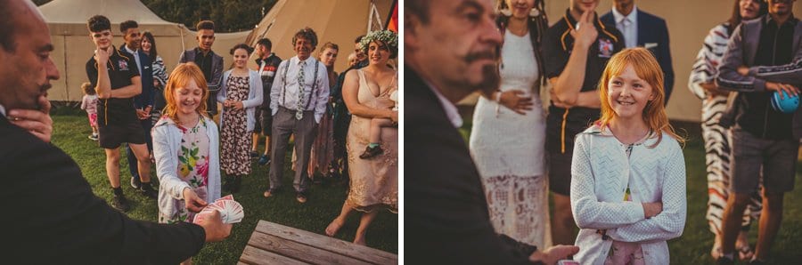 A girl listens to a magician at Hadsham Farm