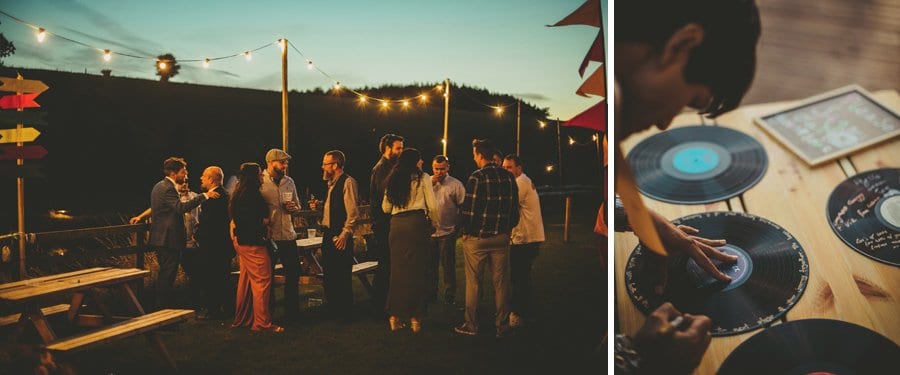 Wedding guests drinking alcohol and chatting amongst each other in the garden at Hadsham Farm