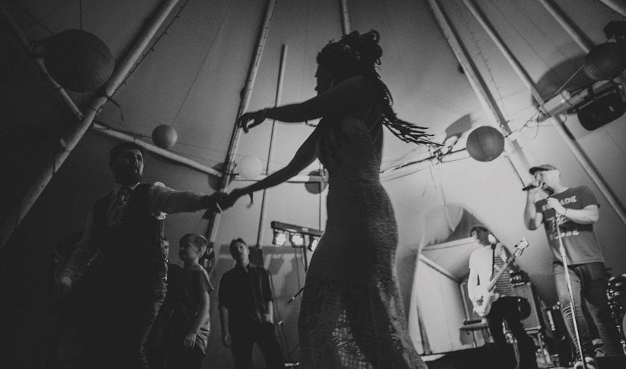 The bride dancing with the groom on the dancefloor in the tipi
