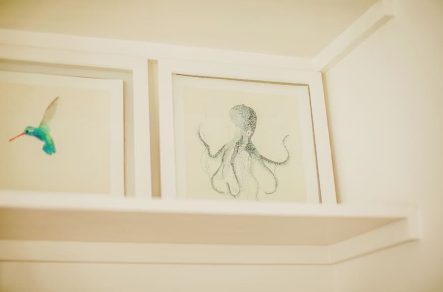 The bride and grooms framed prints on a shelf in the house