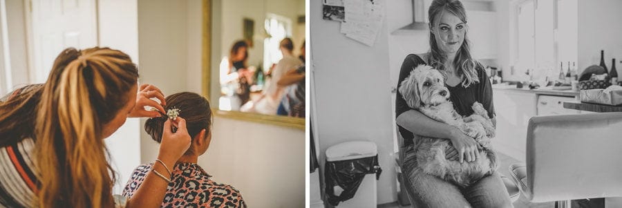 A bridesmaid holds a dog on her lap and the hairdresser attends to the back of a bridesmaids head