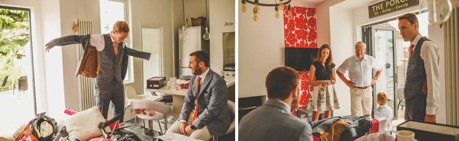 The grooms family watch as the groom puts his suit jacket on