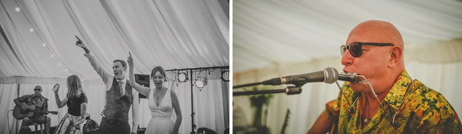 The bride and groom hold their hands in the air on the dancefloor