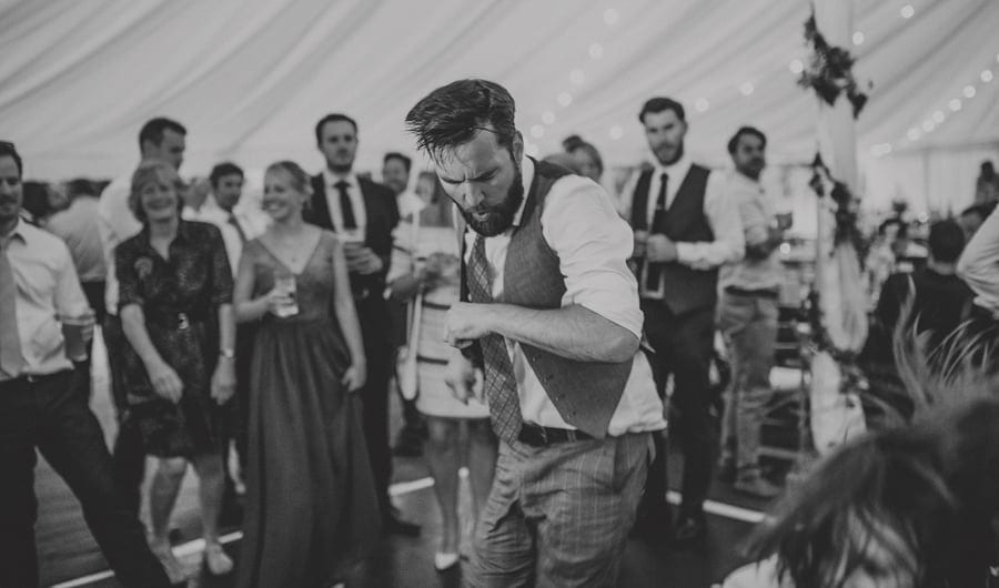 A wedding guest on the dancefloor in the marquee at Hanham Court