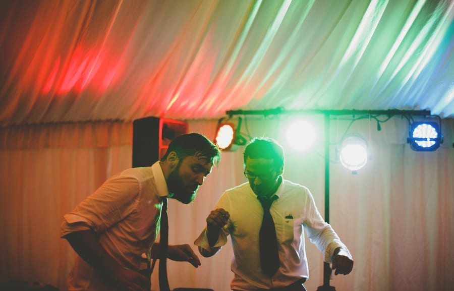 Two men dancing on the dancefloor in the marquee at Hanham Court in Bristol