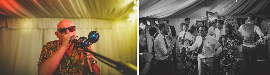 A man performs a song for the wedding guests in the marquee