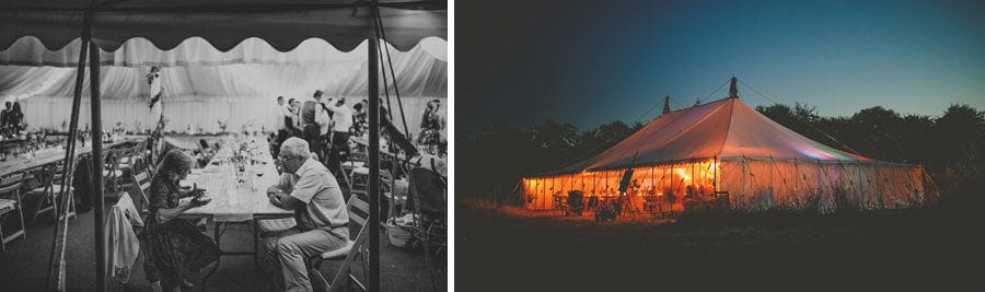 A lady and a man sat talking to each other in the marquee