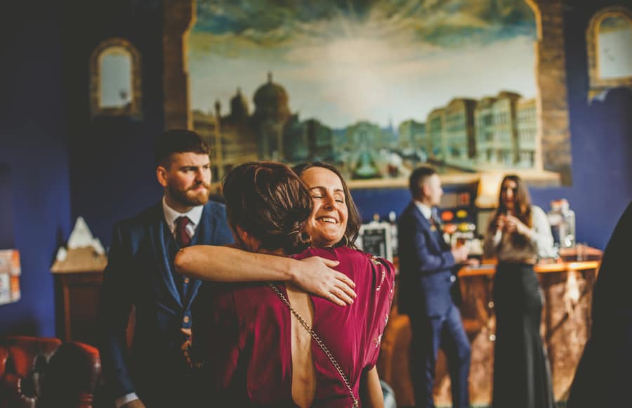 A wedding guest puts her arm around a friend at Kings Weston House in Bristol
