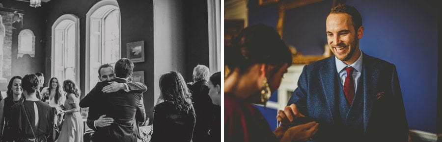 The groom puts his arms around a wedding guest