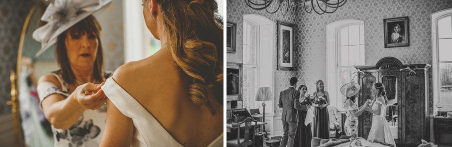 The mother of the bride straightens the brides shoulder strap of her wedding dress