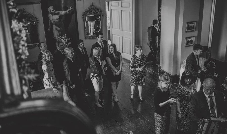Wedding guests start to walk across Kings Weston House