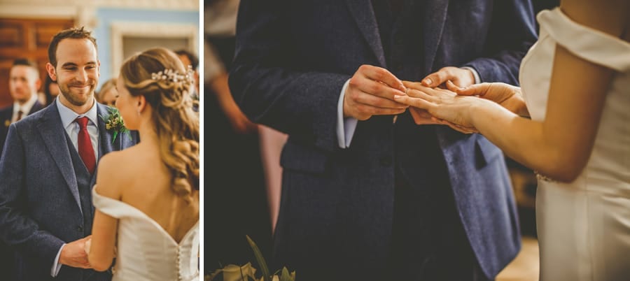 The bride and groom exchange wedding rings during the ceremony at Kings Weston House in Bristol