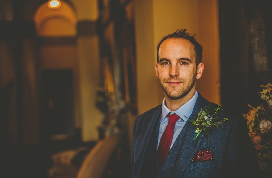 The groom poses for a photograph at Kings Weston House