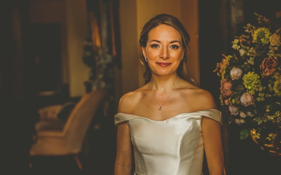 The bride poses for a photograph at Kings Weston House in Bristol