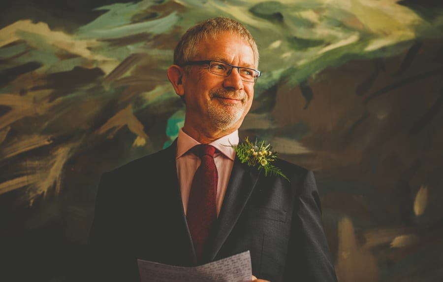 The brides father smiles during his wedding speech