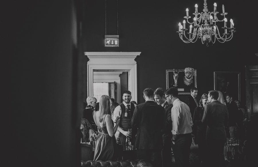 Wedding guests talk to each other at Kings Weston House