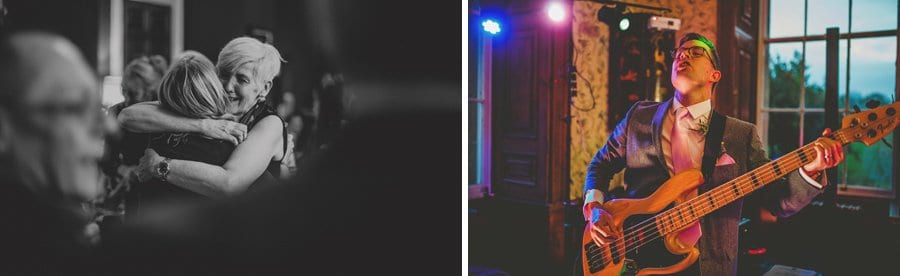 Wedding guests on the dancefloor and the guitarist of the wedding band plays his guitar