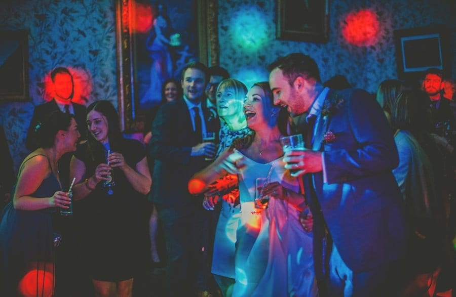 The bride and groom stand next to each other on the dancefloor at Kings Weston House