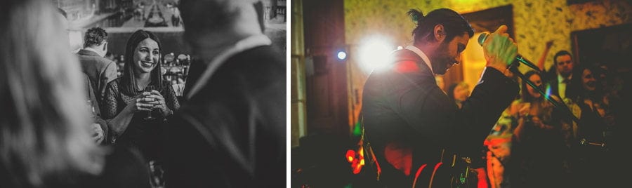 A wedding guest smiles at the bride and groom