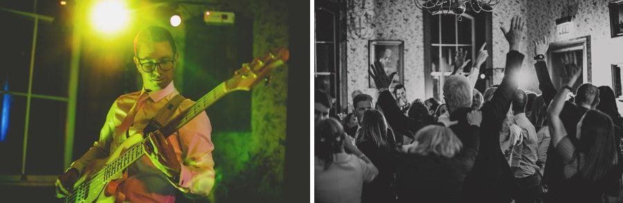 Wedding guests hold up their arms and dance on the dancefloor