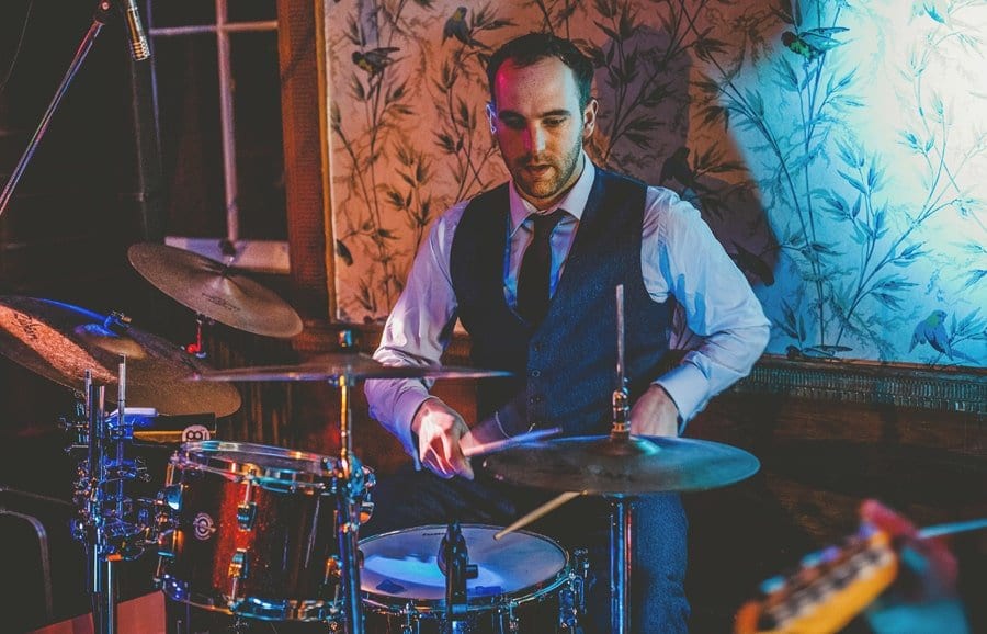 The groom plays drums at Kings Weston House