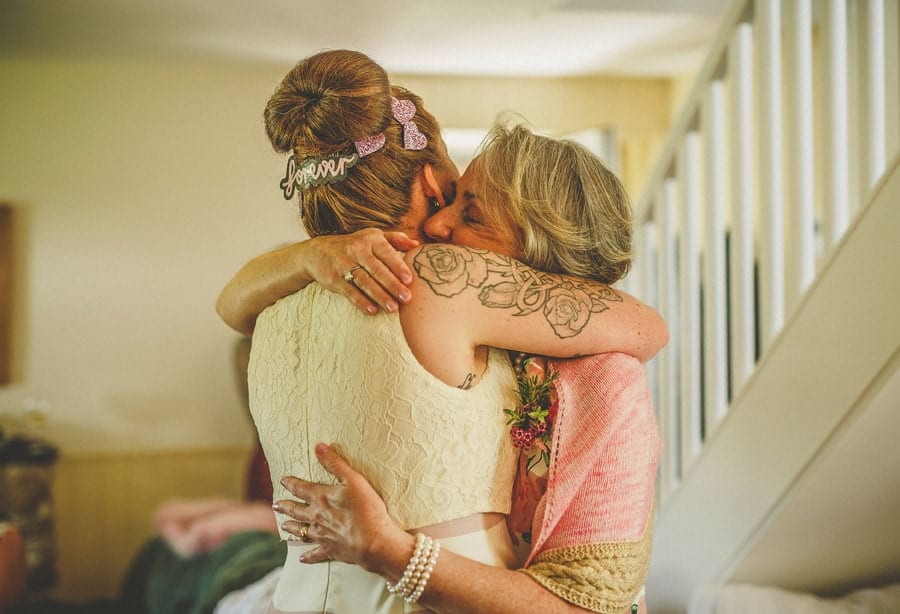 Little Quarme wedding photographer 0018 | somerset-wedding-photographer The bride and her mother hug each other in the cottage at Little Quarme in Minehead, Somerset