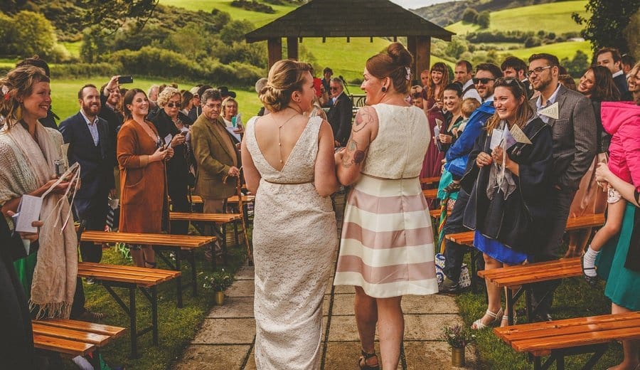 Little Quarme wedding photographer 0025 | somerset-wedding-photographer The wedding couple walk down the aisle together for the outdoor wedding ceremony at Little Quarme Cottages