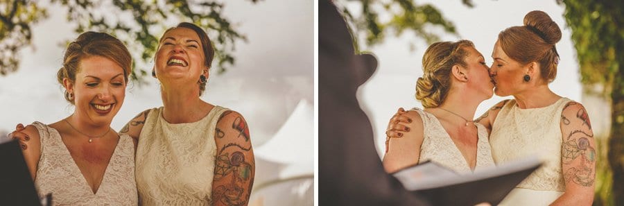Little Quarme wedding photographer 0028 | somerset-wedding-photographer The couple laugh and kiss each other during the outdoor wedding ceremony at Little Quarme Cottages