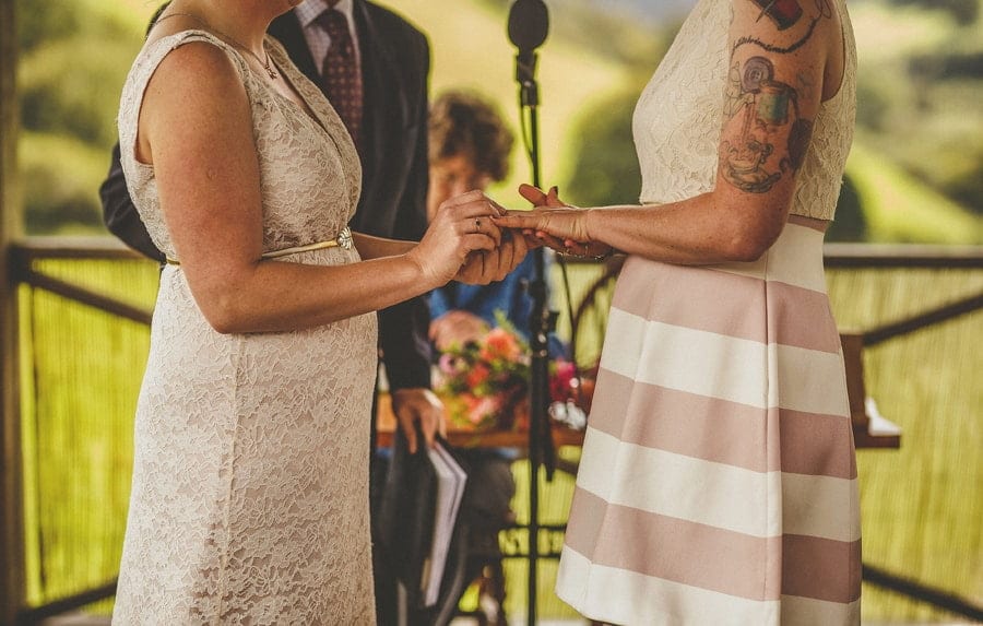 Little Quarme wedding photographer 0030 | somerset-wedding-photographer The bride places a wedding ring on the brides finger during the wedding ceremony