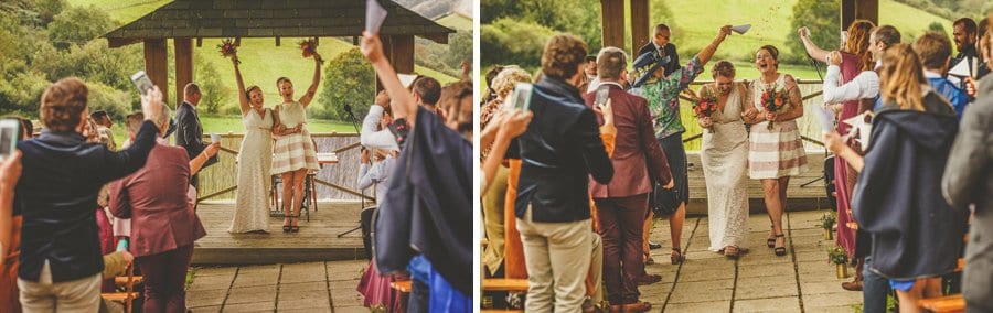 Little Quarme wedding photographer 0033 | somerset-wedding-photographer The bride and bride walk down the aisle of the outdoor ceremony as wedding guests throw confetti in the air