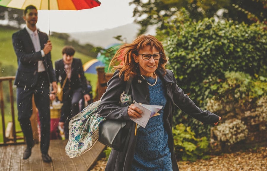 Little Quarme wedding photographer 0037 | somerset-wedding-photographer A wedding guest runs towards the marquee as the rain falls