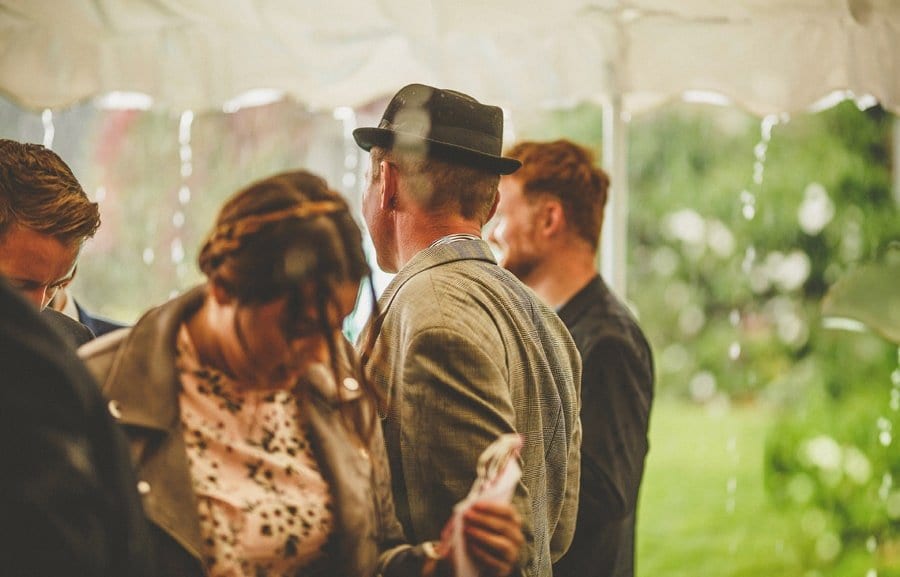 Little Quarme wedding photographer 0039 | somerset-wedding-photographer Wedding guests shelter in the marquee as the rain falls