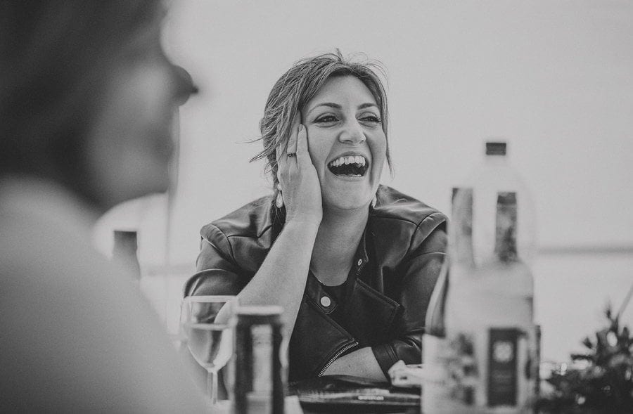 Little Quarme wedding photographer 0048 | somerset-wedding-photographer A wedding guest laughs at a joke being told by the speaker