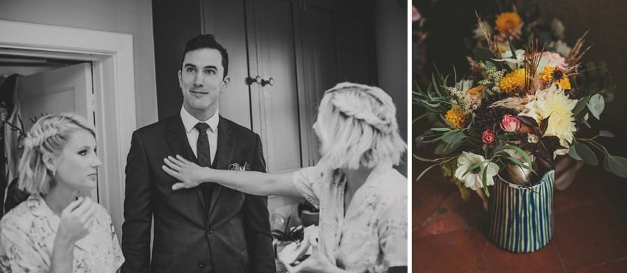 A man stands in the kitchen with two bridesmaids either side of him