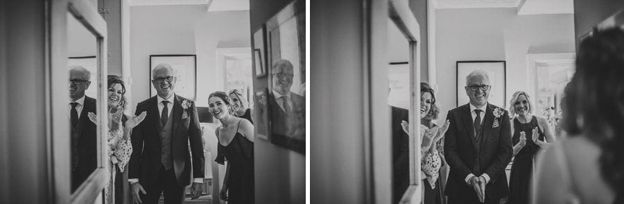The bride's father looks at his daughter for the first time in her wedding dress