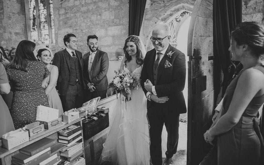The bride and her father walk into the Church together