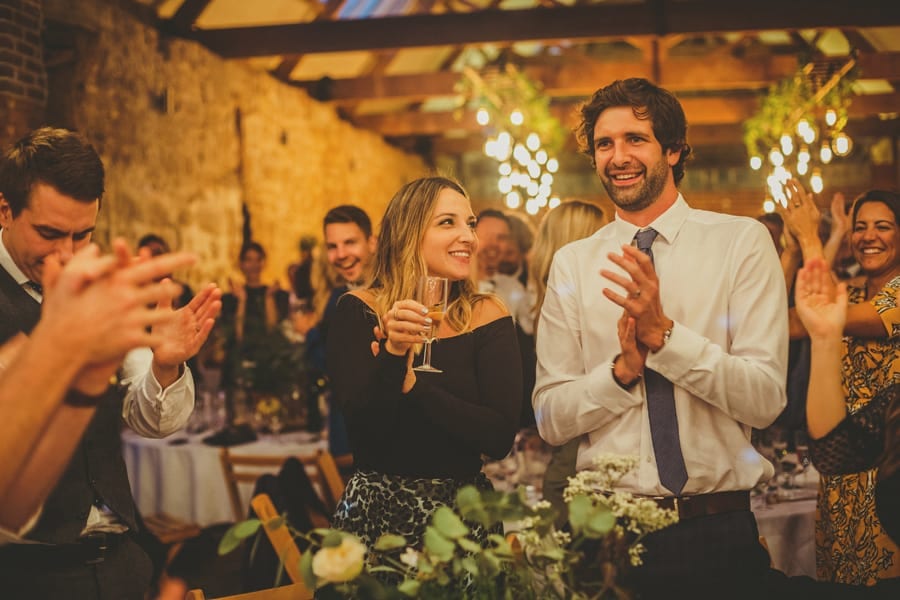 Wedding guests stand up and congratulate the bride and groom
