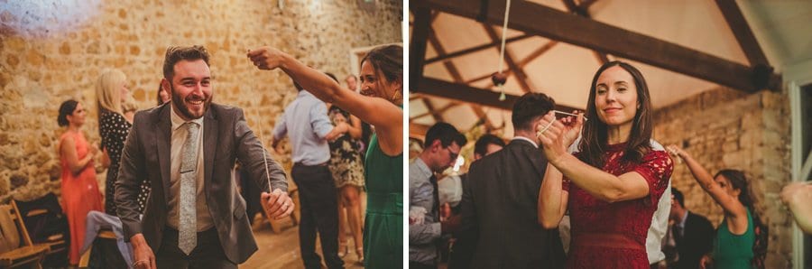 Wedding guests play conkers in the barn
