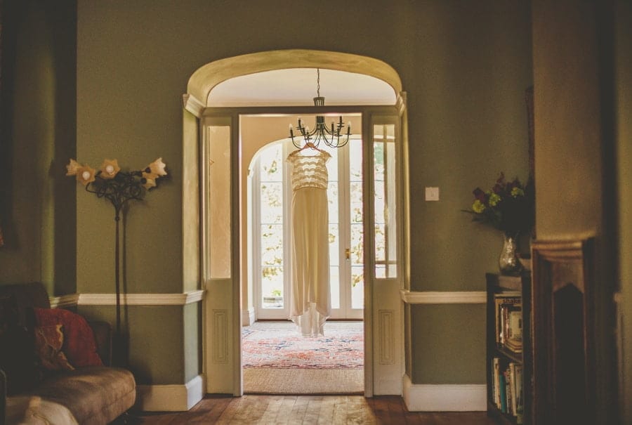 The wedding dress hangs from a chandelier in the house at Matara Centre