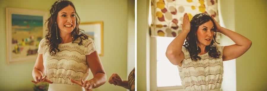 The bride looks in the mirror and straightens her hair