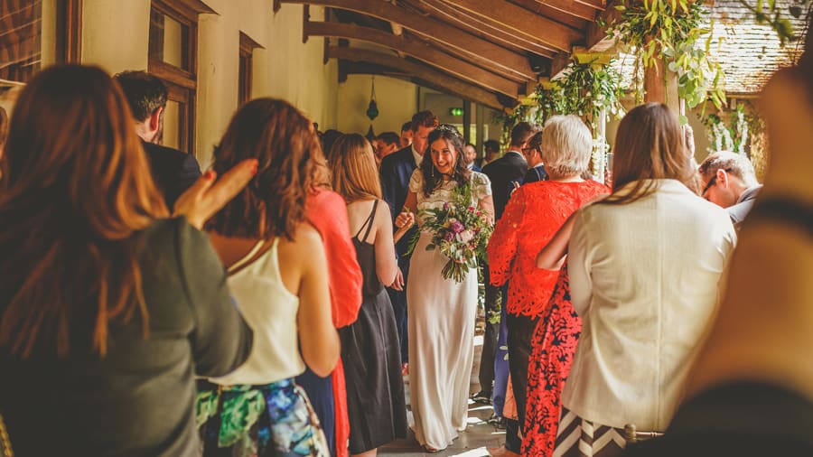 The bride and groom walk down the aisle together after the outdoor ceremony