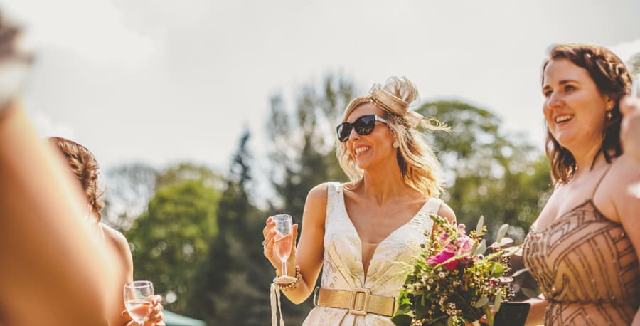 A wedding guest greets the bride and groom