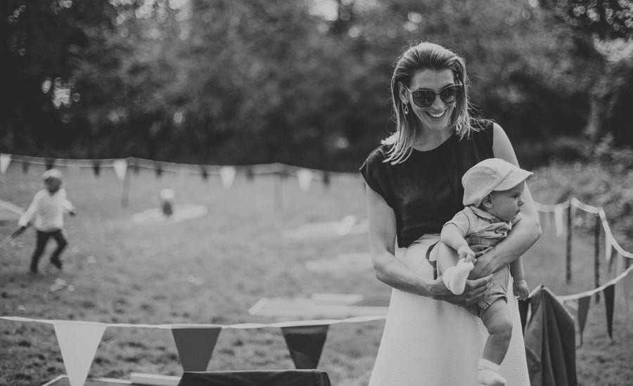 A lady holds her son in her arms and smiles