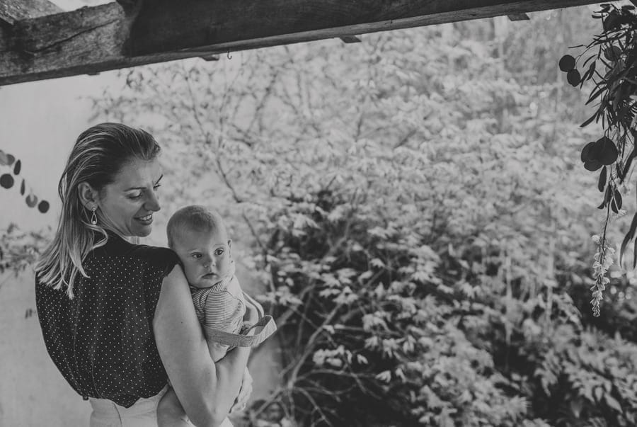 A wedding guest holds her daughter in her arms