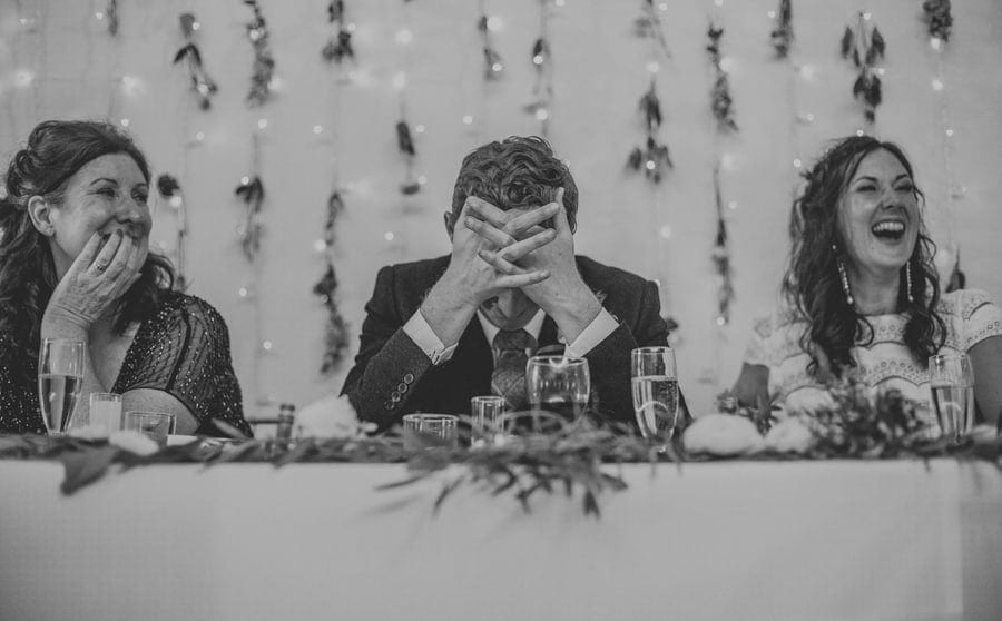 The groom puts his hands on his head