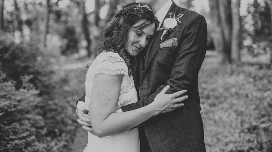 The bride and groom pose for a photograph in the gardens at the Matara Centre