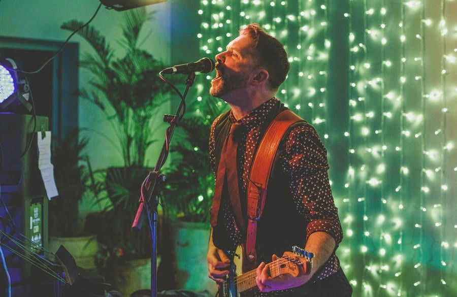 The wedding band perform a song for the wedding party